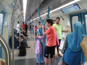 Nicholas (right) and Onn (centre) in the MRT