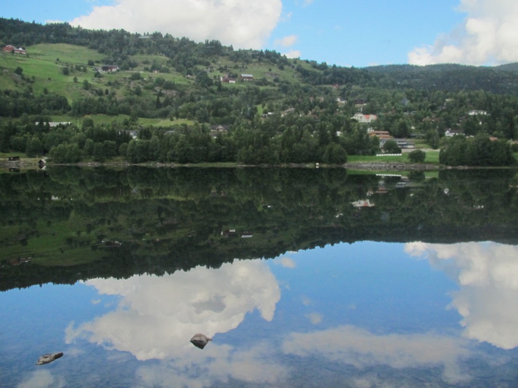 The clear blue sky reflected in the lake in late summer. Nature's beauty greets us on our train ride to Mrydal