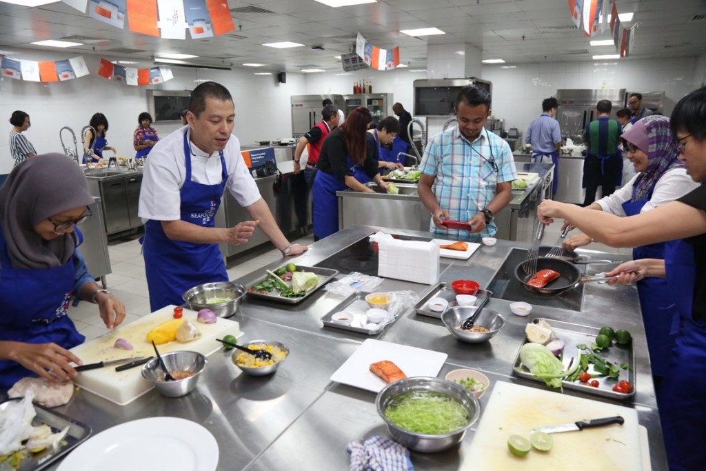 Everyone's busy in the kitchen. Chef Jimmy goes round giving helpful tips