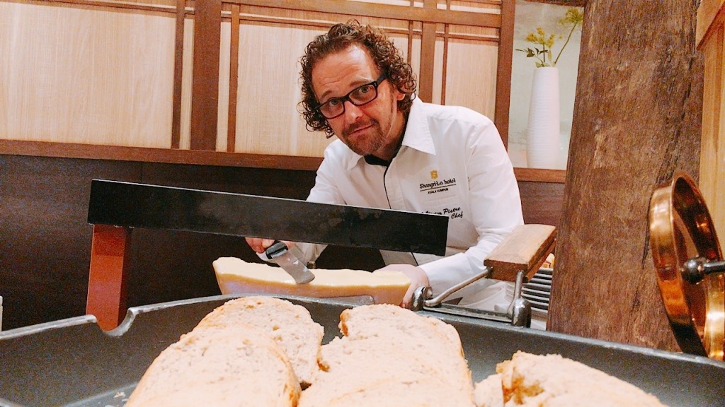 Executive Chef Olivier presents raclette cheese with farmer's bread, pickles and bresaola