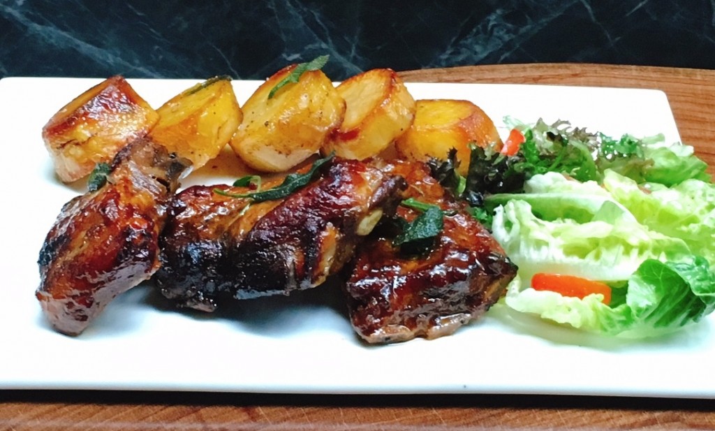 Costolette di Maiale -- Grilled pork ribs with barbecue sauce, served with roasted potatoes and salad